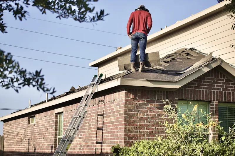 Professional roofer working on a residential roof in Isla Del Sol